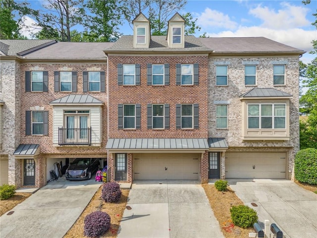 286 Blue Pointe Ct, Suwanee, GA 30024 - townhome / multi-family property with driveway, a garage, a standing seam roof, and brick siding