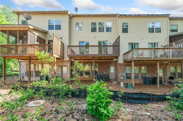 286 Blue Pointe Ct, Suwanee, GA 30024 - back of house with a sunroom, cooling unit, and brick siding