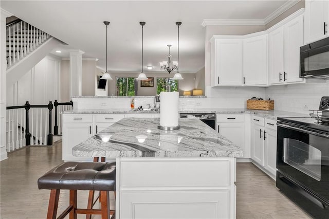 286 Blue Pointe Ct, Suwanee, GA 30024 - kitchen featuring black appliances, decorative backsplash, a center island, and crown molding