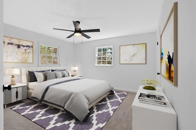 carpeted bedroom with a ceiling fan and baseboards