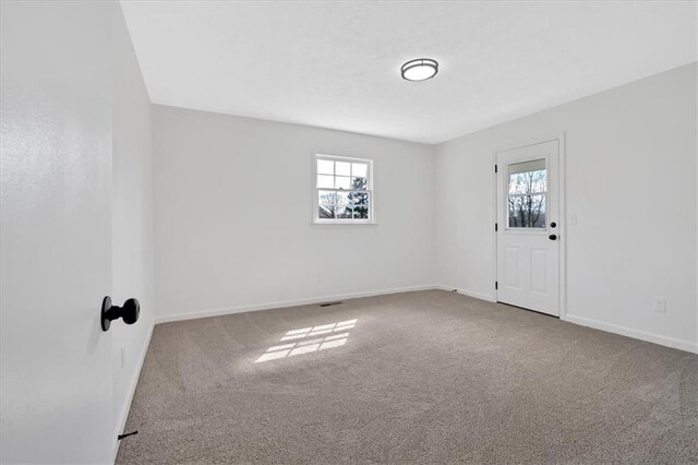 unfurnished room with baseboards and carpet floors