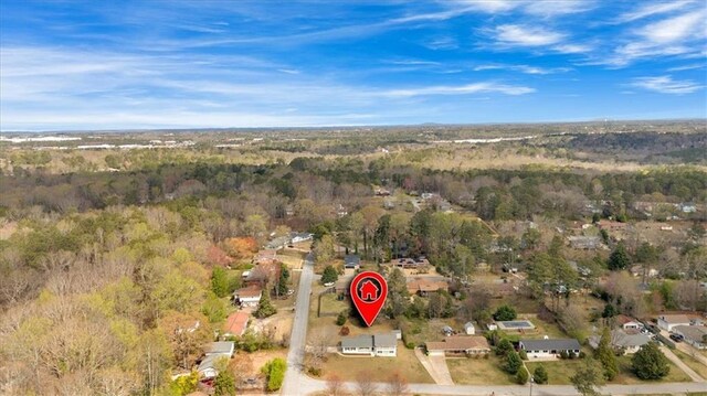 drone / aerial view featuring a view of trees
