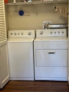 laundry area with laundry area, dark wood-style flooring, and washer and clothes dryer