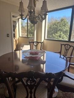 dining space with plenty of natural light and an inviting chandelier