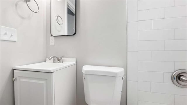 bathroom featuring toilet and vanity