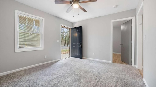 spare room featuring a ceiling fan, baseboards, and carpet floors