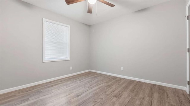 empty room featuring baseboards, ceiling fan, and light wood finished floors