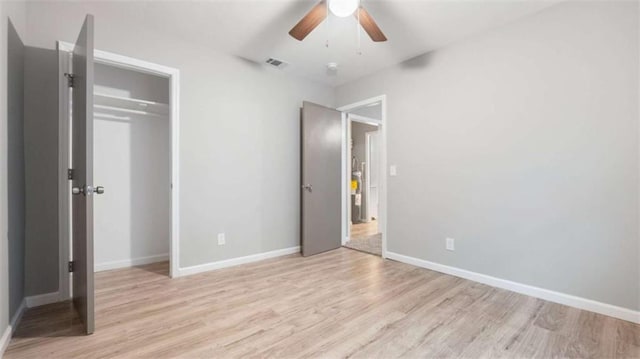 unfurnished bedroom with visible vents, a ceiling fan, a closet, light wood finished floors, and baseboards