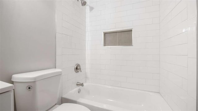 bathroom featuring shower / tub combination and toilet