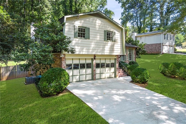 view of side of home featuring a garage, a yard, and central AC unit