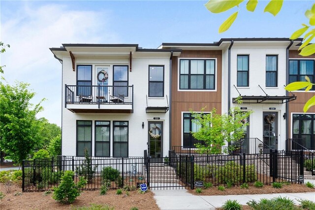 300 Olmstead Way, Alpharetta, GA 30022 - townhome / multi-family property featuring a balcony and a fenced front yard