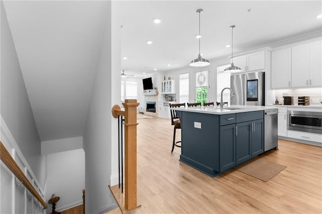 300 Olmstead Way, Alpharetta, GA 30022 - kitchen featuring stainless steel appliances, a sink, white cabinets, light wood finished floors, and recessed lighting