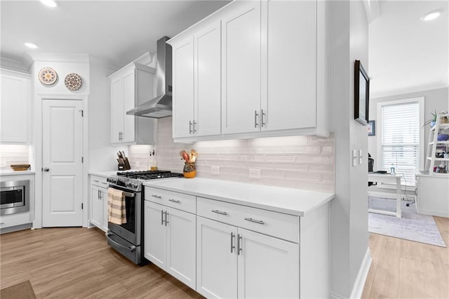 300 Olmstead Way, Alpharetta, GA 30022 - kitchen with stainless steel appliances, wall chimney range hood, light wood-type flooring, light countertops, and recessed lighting