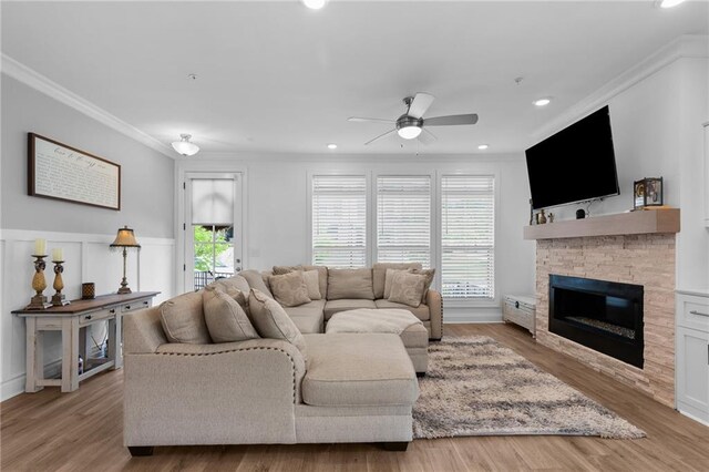 300 Olmstead Way, Alpharetta, GA 30022 - living room with ornamental molding, ceiling fan, a stone fireplace, recessed lighting, and light wood-style flooring