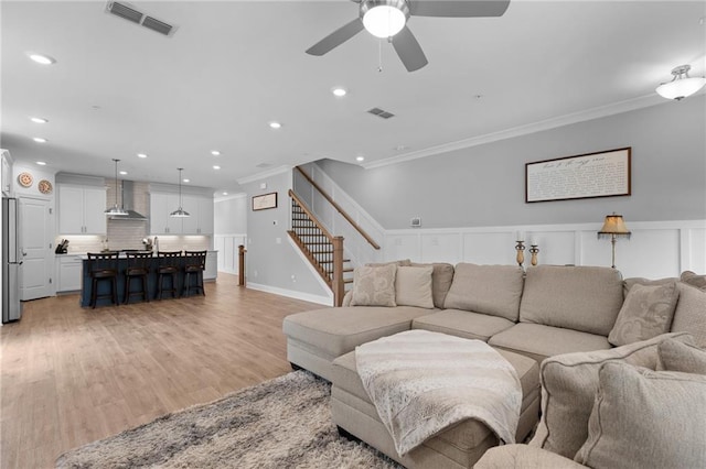 300 Olmstead Way, Alpharetta, GA 30022 - living room featuring crown molding, a ceiling fan, stairway, light wood finished floors, and recessed lighting