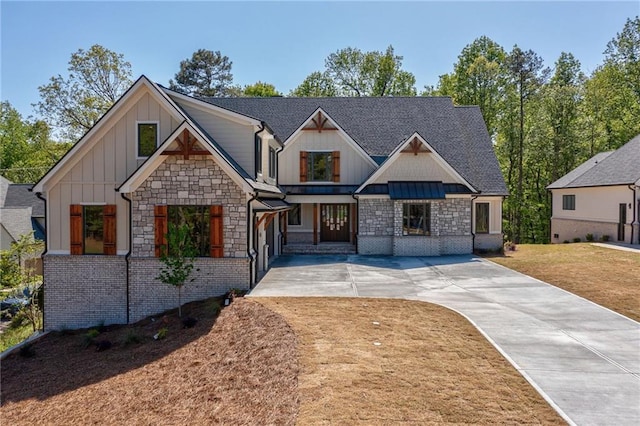 craftsman-style house featuring board and batten siding, concrete driveway, and stone siding