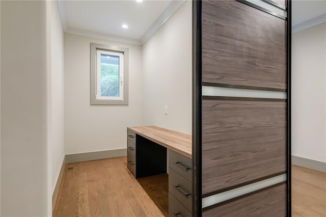 unfurnished office featuring baseboards, ornamental molding, light wood-style flooring, and recessed lighting