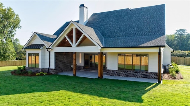 back of house with a patio, fence, a yard, and a chimney