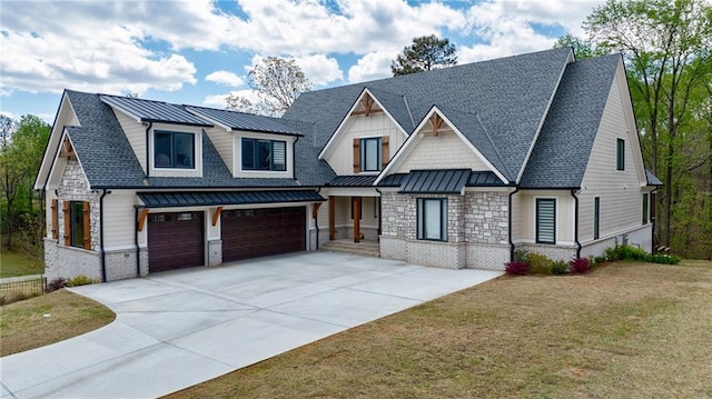 view of front of home with concrete driveway, an attached garage, a standing seam roof, and roof with shingles