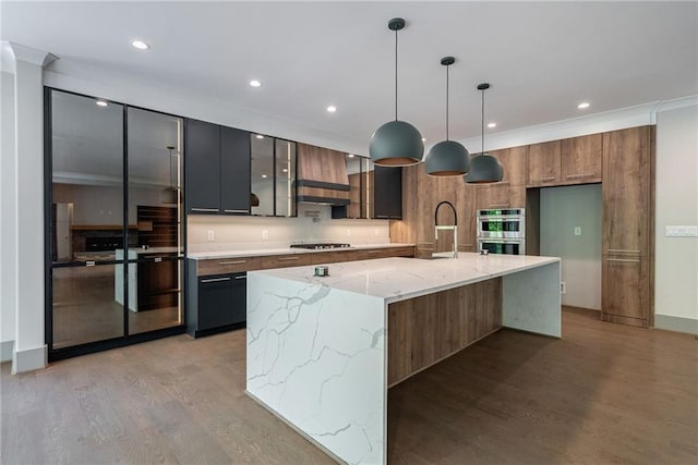 kitchen with light wood-style floors, modern cabinets, double oven, and a sink