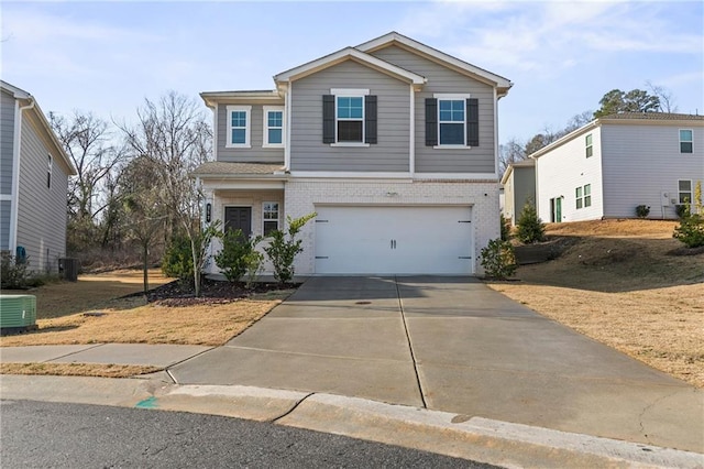 view of front property featuring a garage and central AC