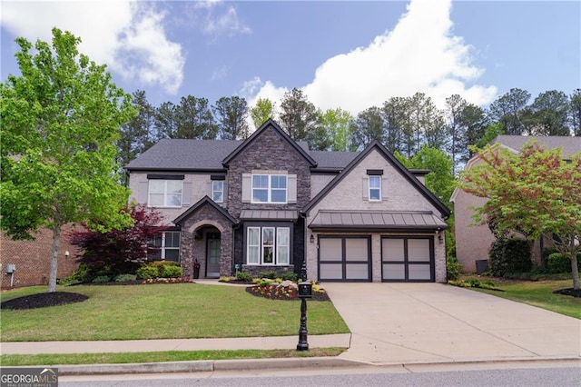 craftsman-style house with a front yard, driveway, a garage, and a standing seam roof