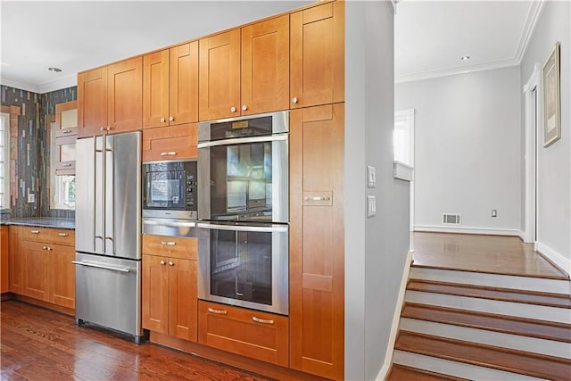 kitchen with crown molding, dark hardwood / wood-style flooring, and stainless steel appliances