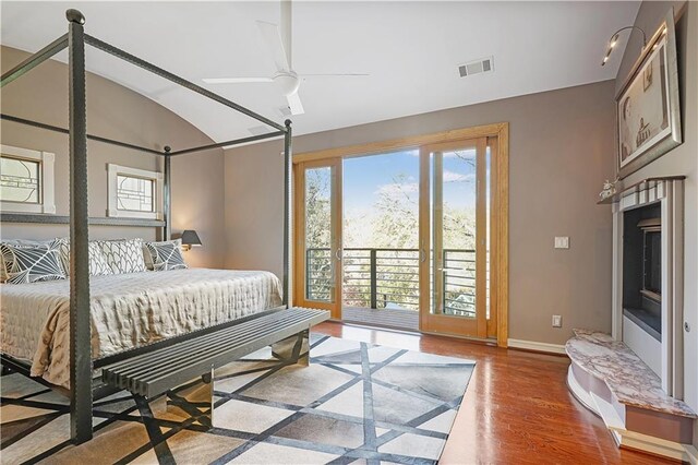 bedroom featuring access to exterior, ceiling fan, wood-type flooring, and lofted ceiling