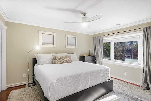 bedroom featuring ceiling fan, dark hardwood / wood-style floors, and ornamental molding