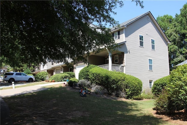 view of home's exterior featuring a yard and covered porch