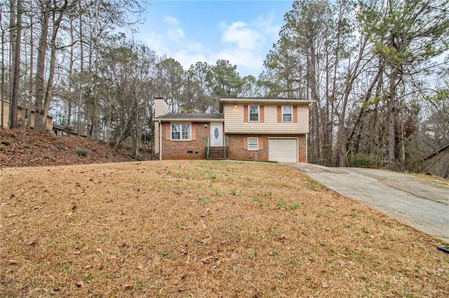 tri-level home featuring entry steps, a garage, brick siding, concrete driveway, and a chimney