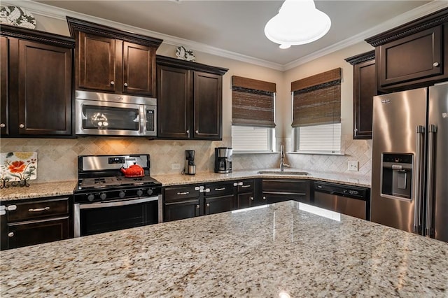 4305 Hunters Walk Way, Cumming, GA 30028 - kitchen featuring appliances with stainless steel finishes, a sink, dark brown cabinetry, light stone countertops, and crown molding
