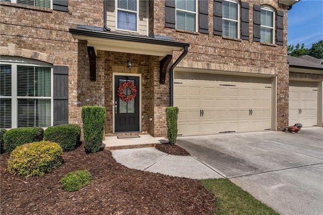 4305 Hunters Walk Way, Cumming, GA 30028 - property entrance with an attached garage, concrete driveway, and brick siding