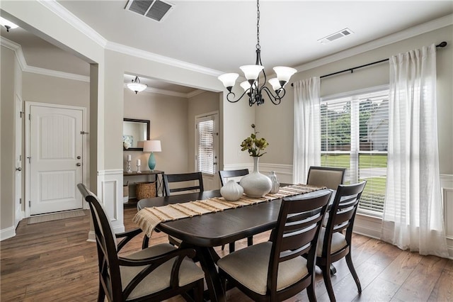 4305 Hunters Walk Way, Cumming, GA 30028 - dining room featuring wood-type flooring, a chandelier, crown molding, and a wainscoted wall