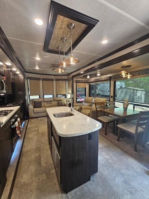 32 7th St, Ellijay, GA 30540 - kitchen featuring a sink, light countertops, open floor plan, and pendant lighting