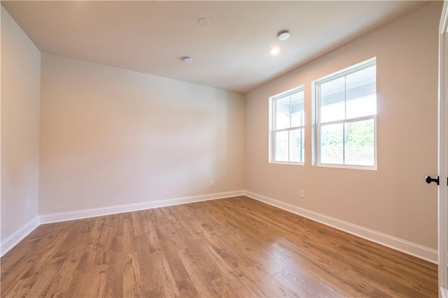 unfurnished room with wood-type flooring