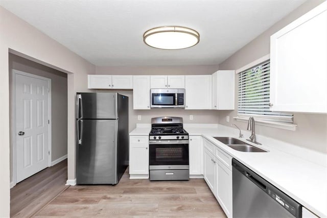 5290 Forest Downs Ln, Atlanta, GA 30349 - kitchen with stainless steel appliances, a sink, and white cabinetry