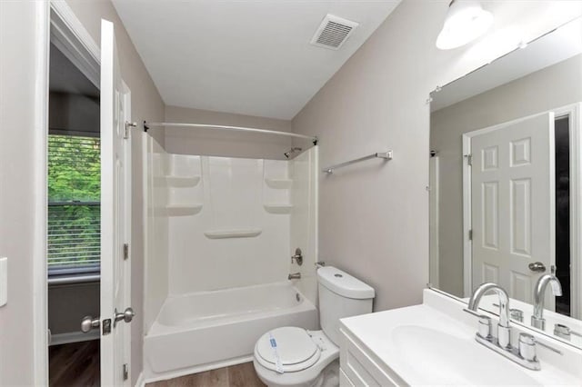 5290 Forest Downs Ln, Atlanta, GA 30349 - bathroom with toilet, wood finished floors, vanity, and bathing tub / shower combination
