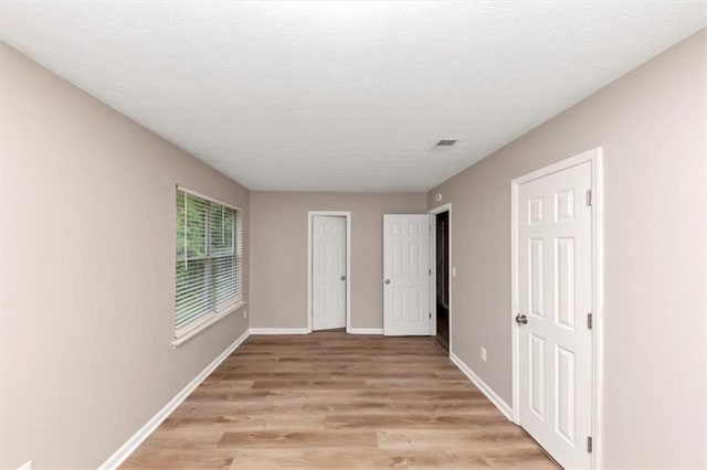 5290 Forest Downs Ln, Atlanta, GA 30349 - unfurnished bedroom featuring light wood-style flooring and baseboards