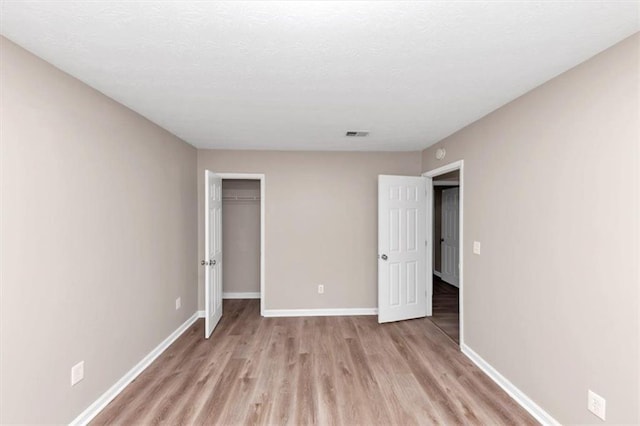 5290 Forest Downs Ln, Atlanta, GA 30349 - unfurnished bedroom featuring light wood finished floors, baseboards, and a closet