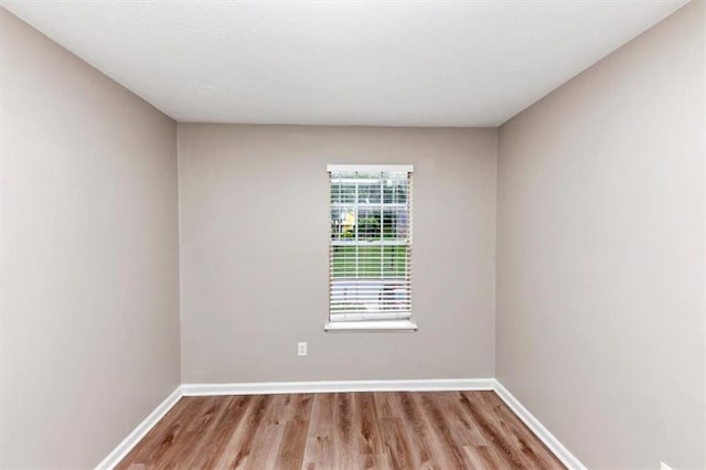 5290 Forest Downs Ln, Atlanta, GA 30349 - empty room with wood finished floors and baseboards