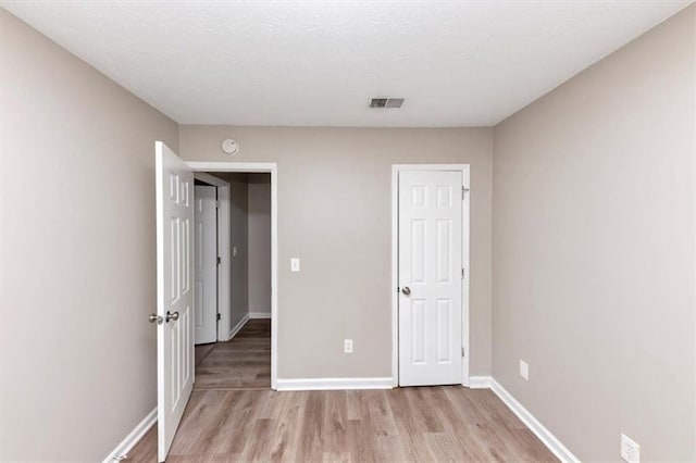 5290 Forest Downs Ln, Atlanta, GA 30349 - unfurnished bedroom with light wood-type flooring and baseboards