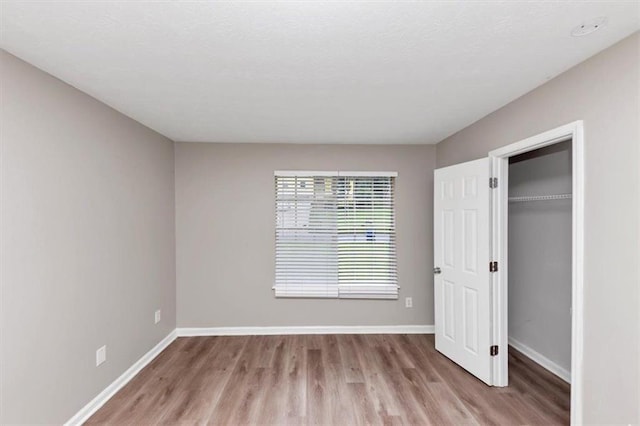 5290 Forest Downs Ln, Atlanta, GA 30349 - unfurnished bedroom featuring wood finished floors, baseboards, and a closet