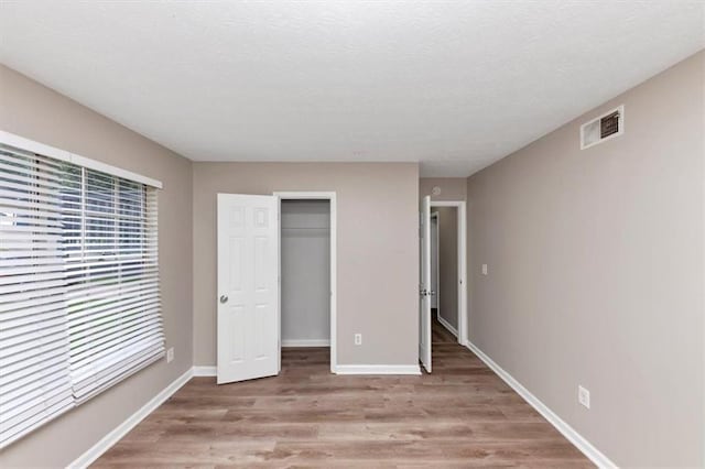 5290 Forest Downs Ln, Atlanta, GA 30349 - unfurnished bedroom featuring wood finished floors, baseboards, and a closet