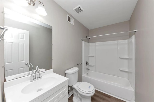 5290 Forest Downs Ln, Atlanta, GA 30349 - bathroom with wood finished floors, toilet, vanity, and shower / bath combination