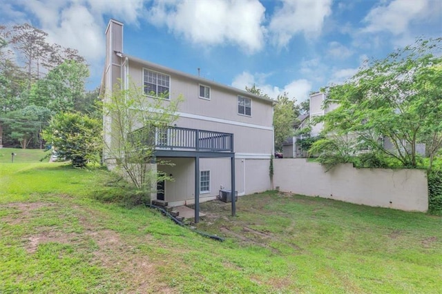 5290 Forest Downs Ln, Atlanta, GA 30349 - rear view of house featuring a deck, a lawn, a chimney, and cooling unit