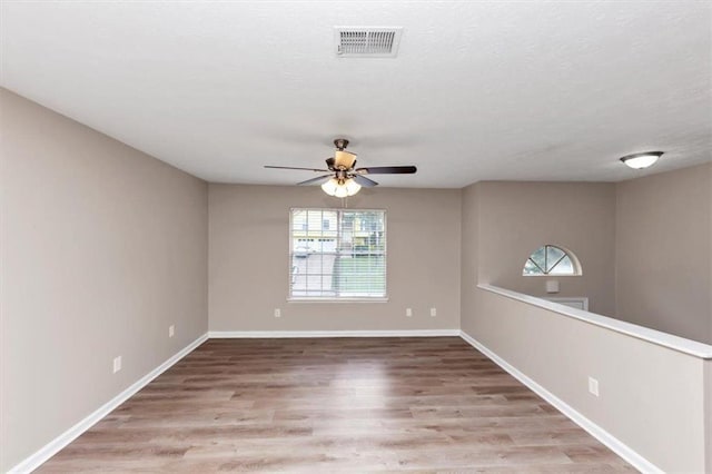 5290 Forest Downs Ln, Atlanta, GA 30349 - spare room featuring plenty of natural light, a ceiling fan, wood finished floors, and baseboards