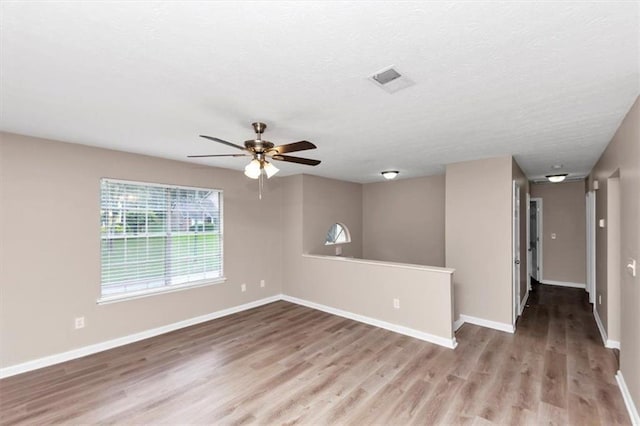 5290 Forest Downs Ln, Atlanta, GA 30349 - spare room featuring wood finished floors, a ceiling fan, and baseboards