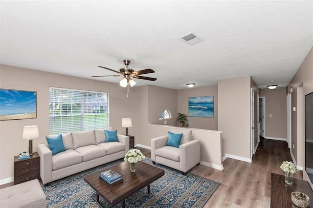 5290 Forest Downs Ln, Atlanta, GA 30349 - living area with baseboards, wood finished floors, and ceiling fan