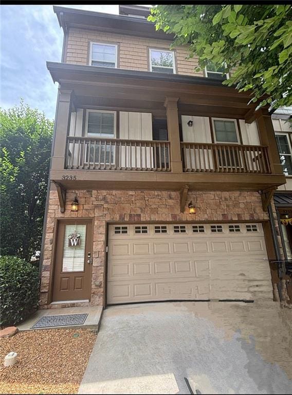 3235 Chutney Ct, Avondale Estates, GA 30002 - view of front of property featuring a garage, a balcony, and stone siding